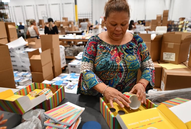 A woman packages products in a brand collateral warehouse