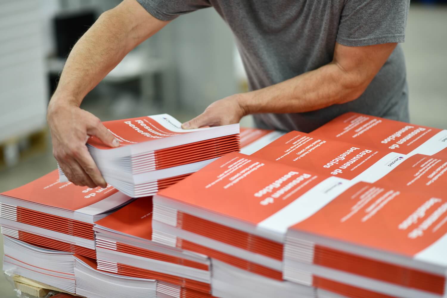 Employee stacking reams of paper