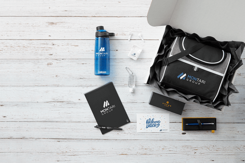 Montari Group promotional products, including a water bottle, notebook, pen, earbuds, and laptop bag