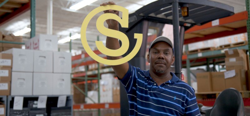 Southeastern employee holding die cut company logo