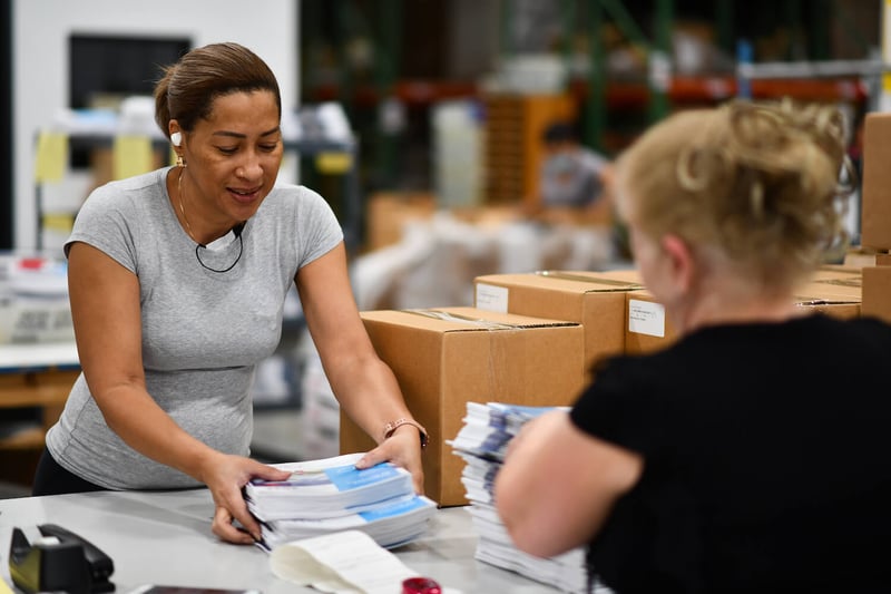 Southeastern Printing employees putting together fulfillment kits