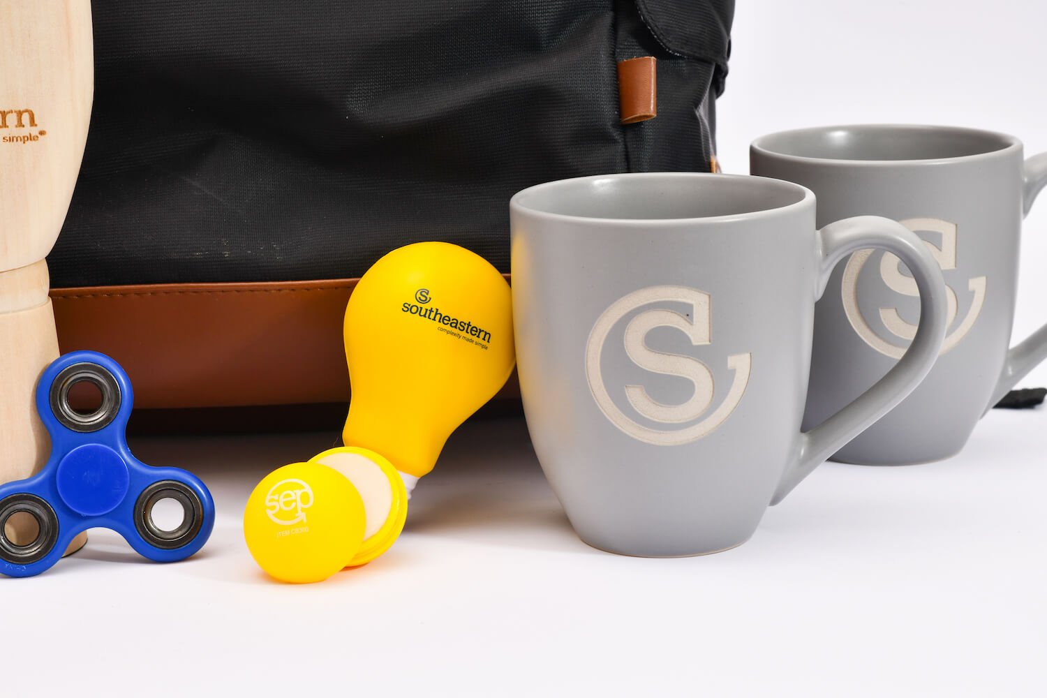 Southeastern branded swag, including a fidget spinner, lip balm, and coffee mugs