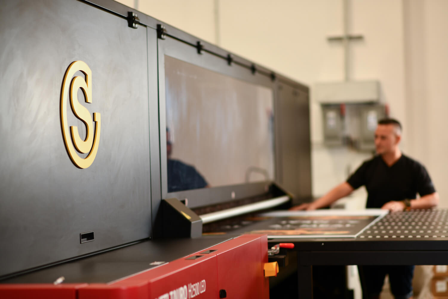 Southeastern employee working on wide format printer